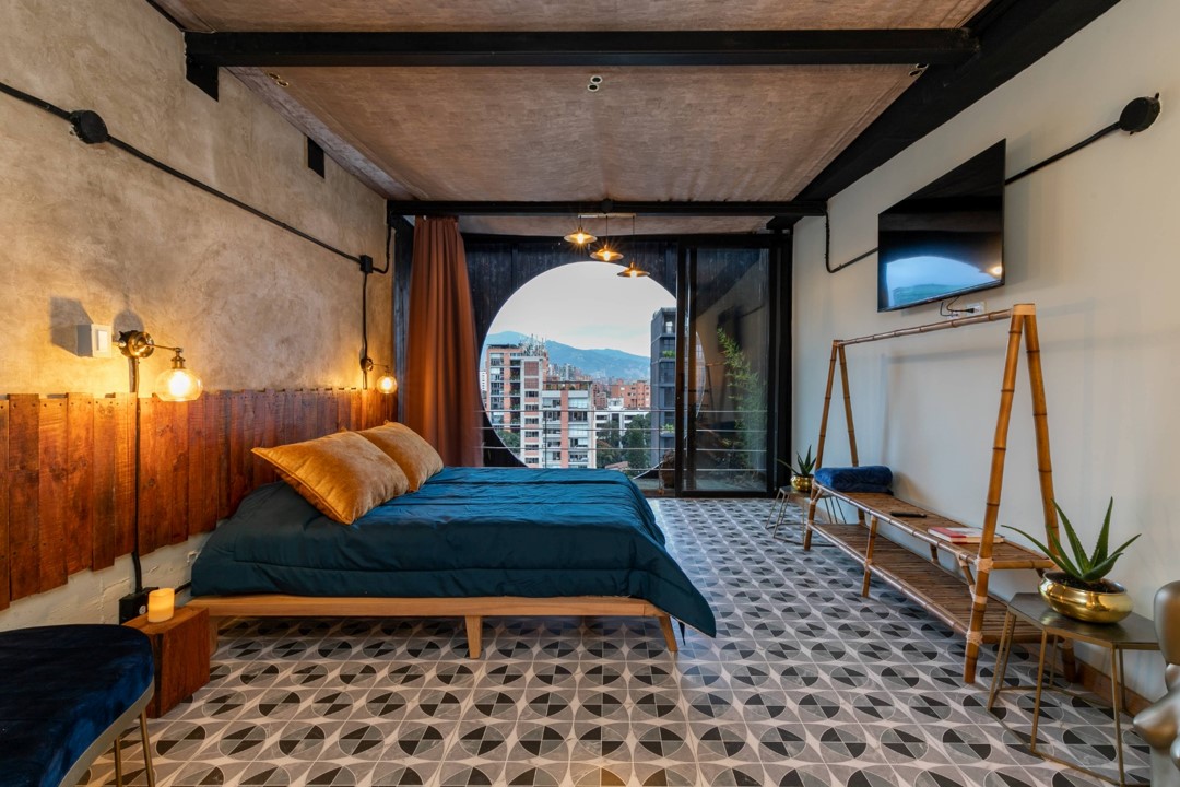 Spacious queen bed with luxury linens in a modern Nido Sky Hotel apartment in Medellin